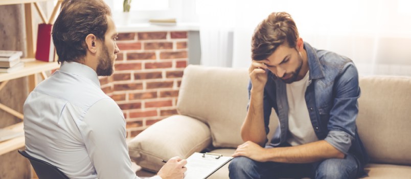 sad man sitting with a therapist
