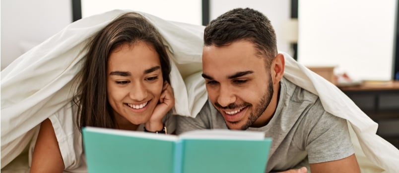 Smart couple reading book together