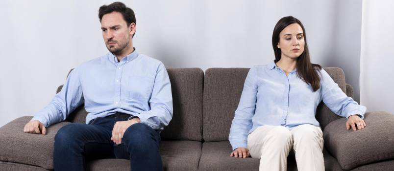 Angry and and woman sitting on couch 