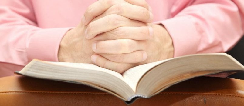 Close Fold Finger Men's Hand With Open Bible Book