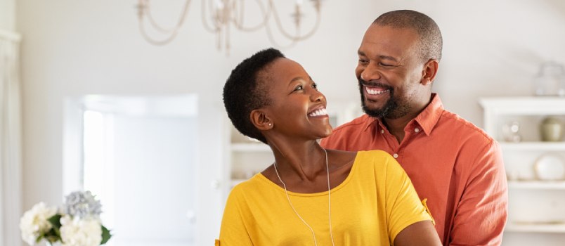 husband and wife holding each other happily