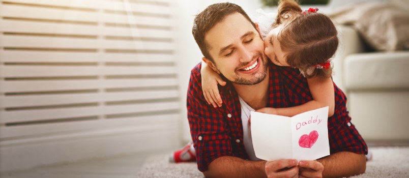 Daughter kissing her father