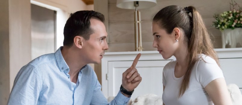 man pointing a finger at woman