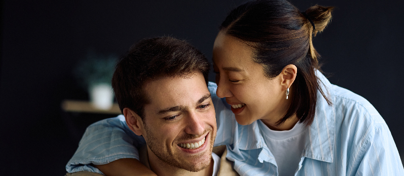 Happy Young Couple Smiling and Embracing at Home