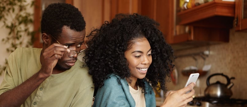Man staring in woman phone