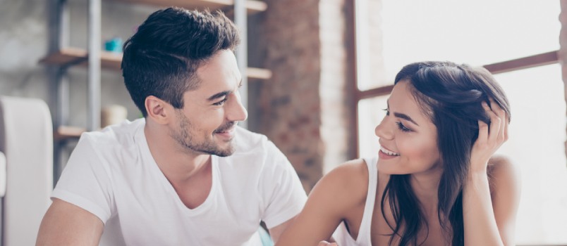 man and woman looking at each other smiling