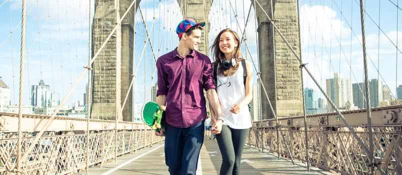 Young Couple Walking On The Brooklyn Bridge Holding Hands Together Smiling Loving Concept