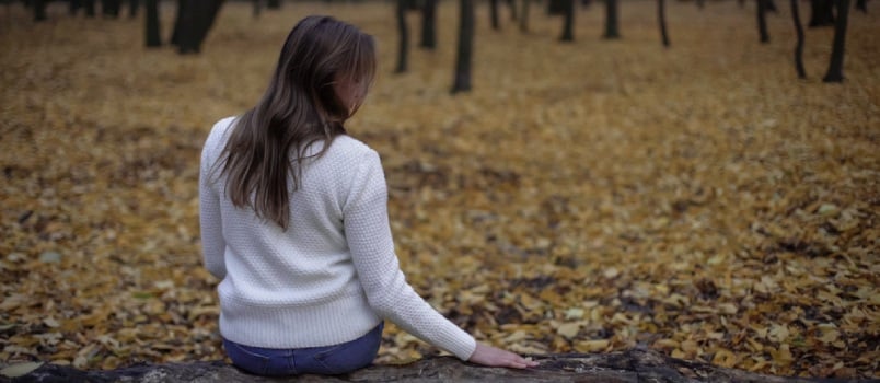 woman sitting on bench missing her man