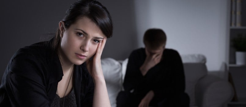 Angry man and woman sitting apart after a fight
