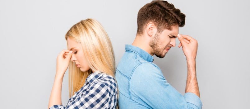 Young Depressed Couple Standing Back To Back, Hand On Head Upset Moment