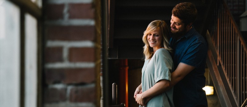 Man Hugging Woman From Behind Near Stair