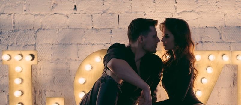 Happy couple in love sitting together in a romantic setting
