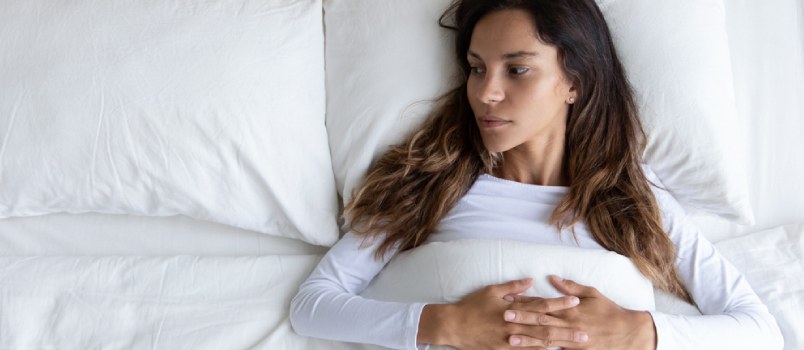 Pensive Young Woman Lying Alone In Cozy White Bed Thinking Or Pondering Over Relationships Problem