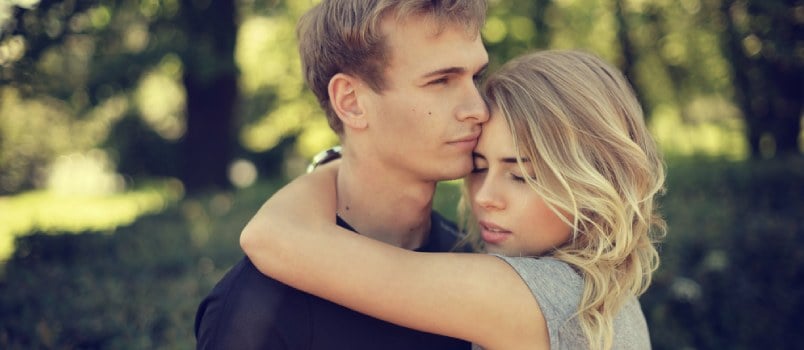 Couple Hugging In Park On A Summer Day