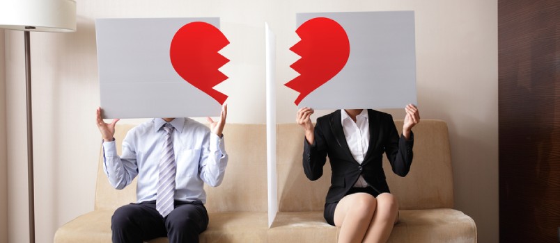 Couple Holding Billboard Sign With Break Love Heart