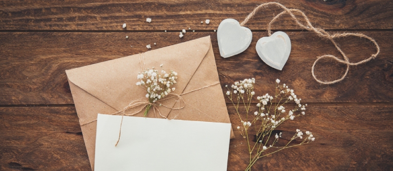 Empty Greeting Card And Flowers With Hearts On Wooden Background