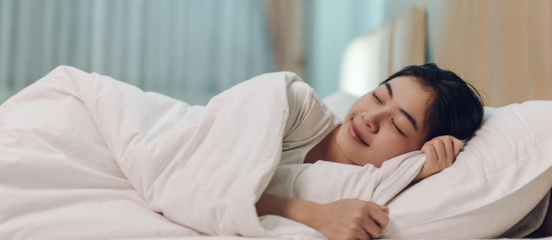 Rest up, sleep, not caffeine Asian Woman Sleeping In A Bed In A Dark Bedroom