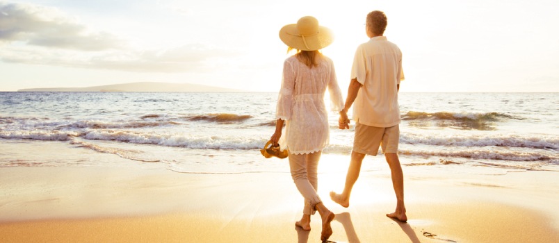 Couple walking at the beach hand in hand