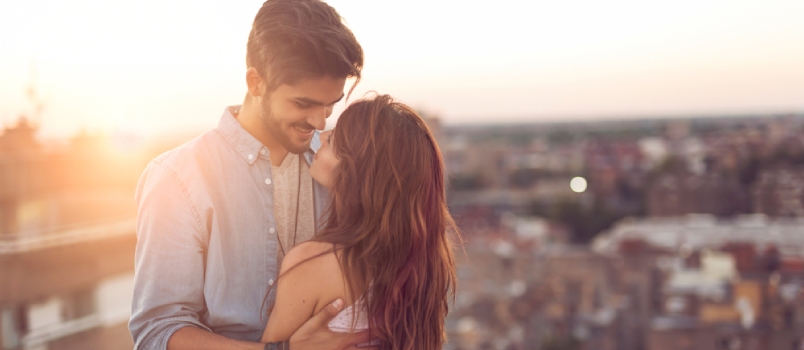 Understanding your partner Couple Hugging And Smiling On The Roof With Side City View