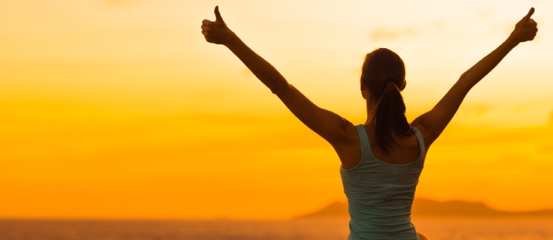 Breaking the inner wall Healthy Woman Celebrating During A Beautiful Sunset