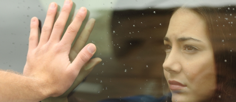 Couple Saying Goodbye Before Car Travel Holding Hands Through The Window