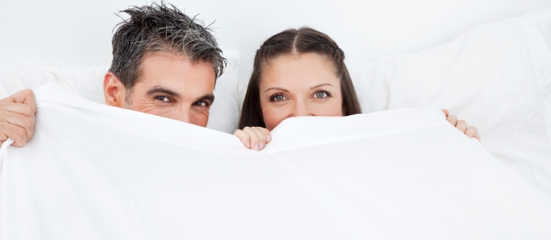 Postpartum Couple Under White Bedsheet