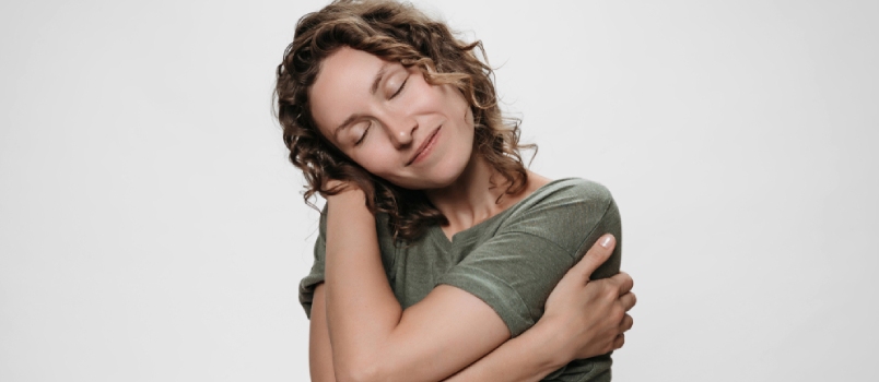 Radical self-acceptance Curly Woman Hugging Herself Looks Happy