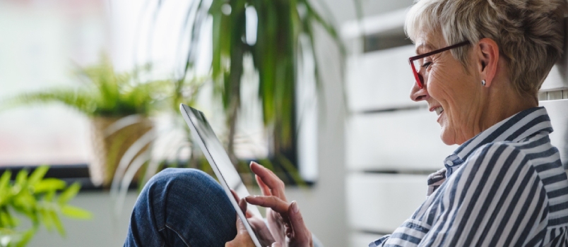 Spend some time alone A Happy Senior Woman Using Digital Tablet At Home