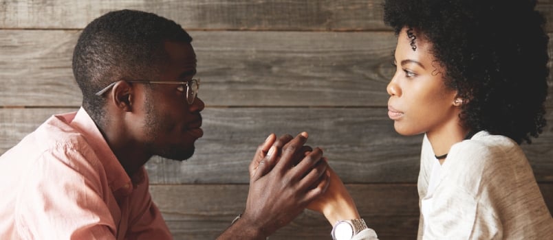 African American Young Couple Holding Hand Together And Sitting At A Cafe Table