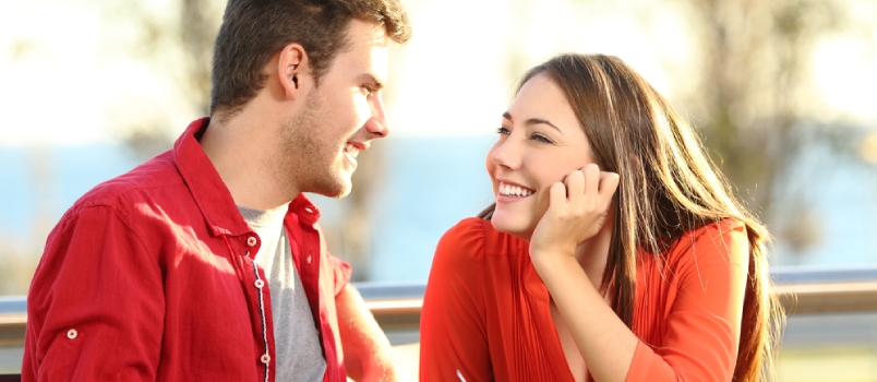 Candid Couple Date Falling In Love Flirting In A Terrace Looking Each Other