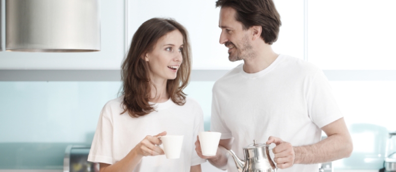 We need to be extra kind and understanding in a marriage at this time. Happy couple cooking breakfast together in the kitchen