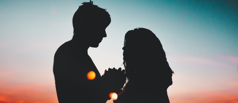 Silhouette of Couple Standing during Nighttime