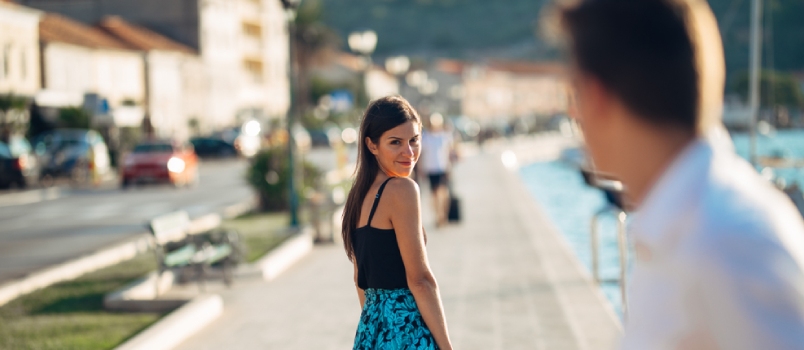 Young Smily Attractive Woman Flirting With A Man On The Street