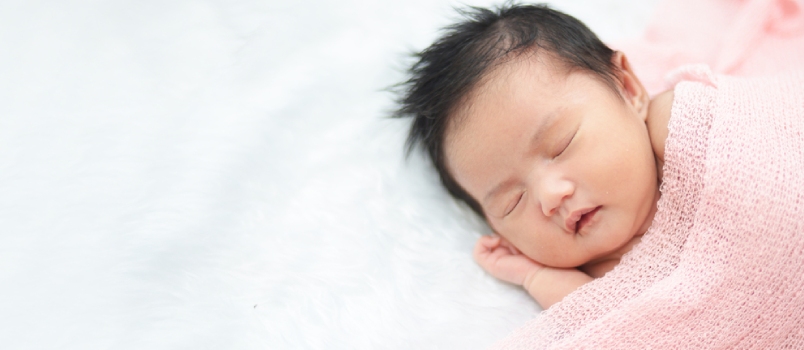 Cute Newborn Asian Girl Sleeping On Furry Cloth Wearing Roses Headband