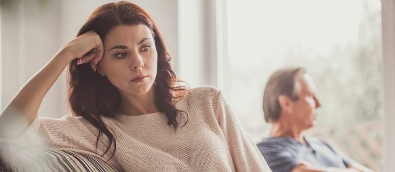 Sad Women And Man Sitting On Couch With Maintaining Sadly Distanced From Each Other