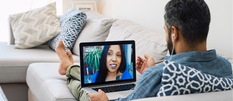 People might prefer long distance relationship Rear View Of Husband Relaxing On Couch While Talking To His Wife Using Laptop At Home