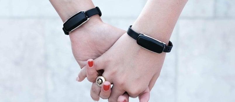 The magic of bond bracelets Couple Holding Each Other Hand With Bond Bracelets