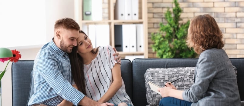 Psychologist Working With Married Couple In Office