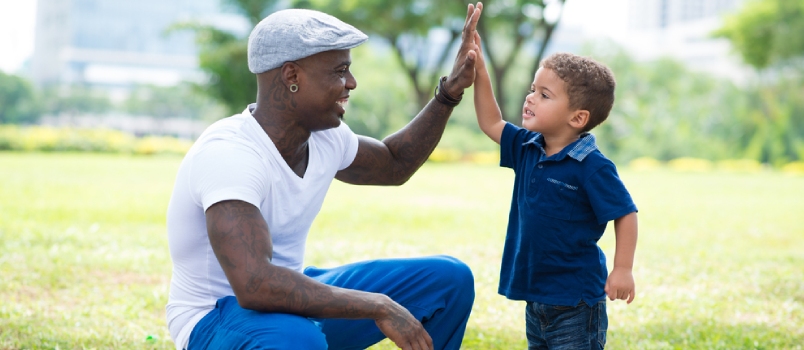 Morden Father Giving A Hi-five His Little Son In The Park