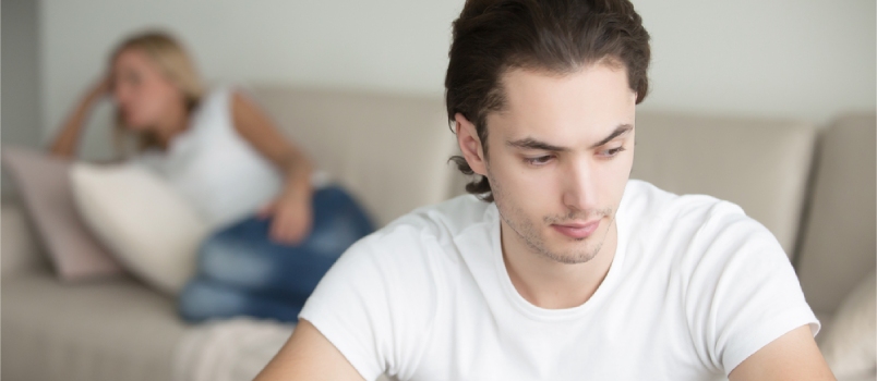 Troubled Young Handsome Man Woman At The Background On The Sofa