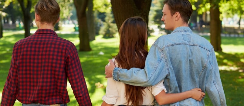 Two Mens One Girl Walking in the Park Behind Shots