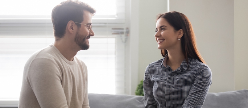Happy Young Man Holding Attractive Woman Hands On Couch Smiling Romantic Couple Enjoy Time Together Beautiful Family Have Fun Time And Enjoy Romantic Pastime