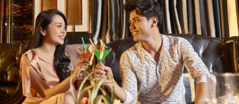Man and woman sitting together drinking