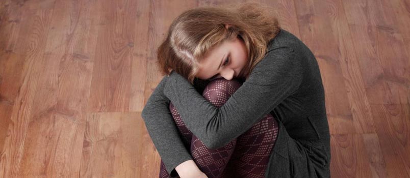 sad woman sitting on floor