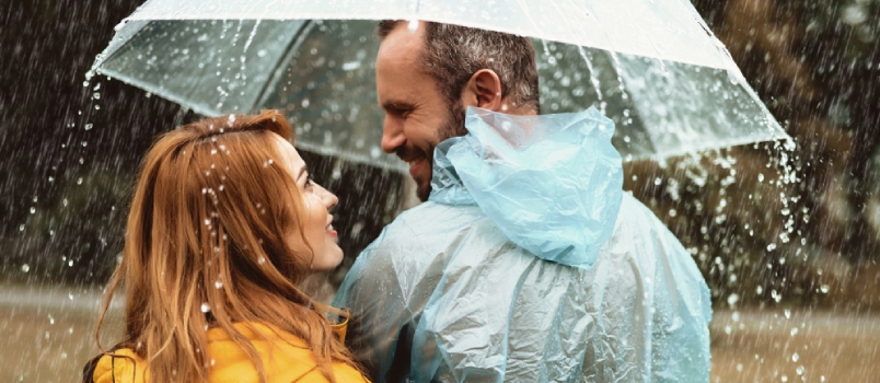 Joyful Man Strolling With Woman In Rain They Are Looking At Each Other With Content And Love