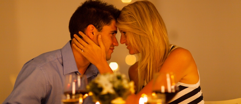 Romantic Dinner Gesture Couple Having Romance On A Restaurant Table