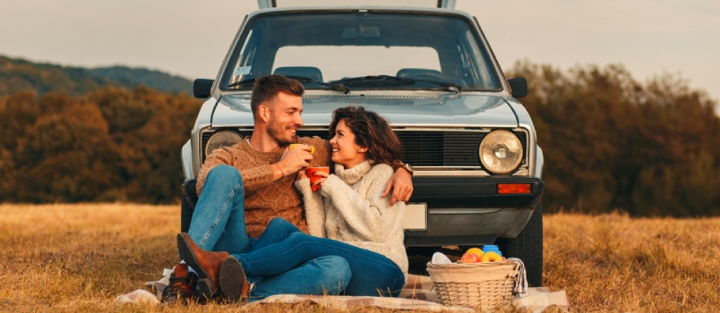 Beautiful Young Couple Enjoying Picnic Time On The Sunset