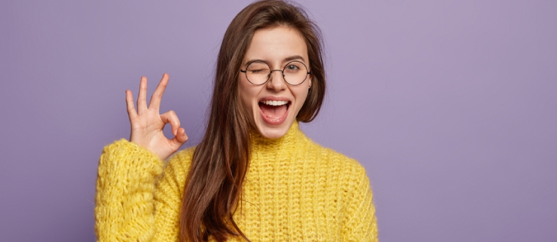 Waist Up Shot Of Pleased Young Woman Says Good Job Or Well Done