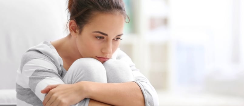 Depressed Young Woman Sitting On Floor At Home In Deep Think Something