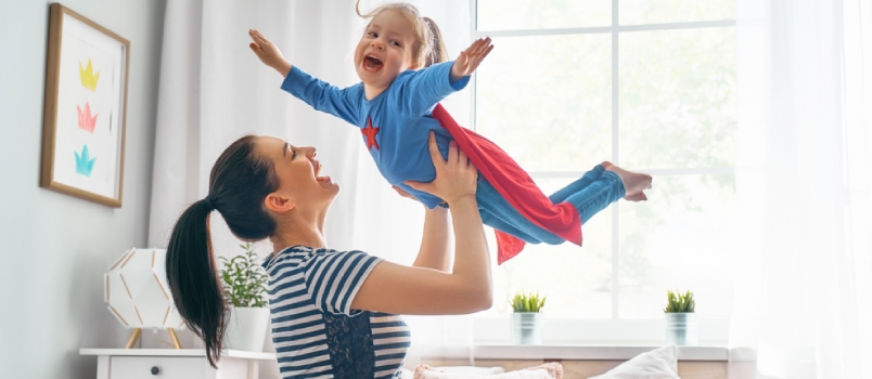 Mother And Her Child Playing Together Girl And Mom In Superhero Costume